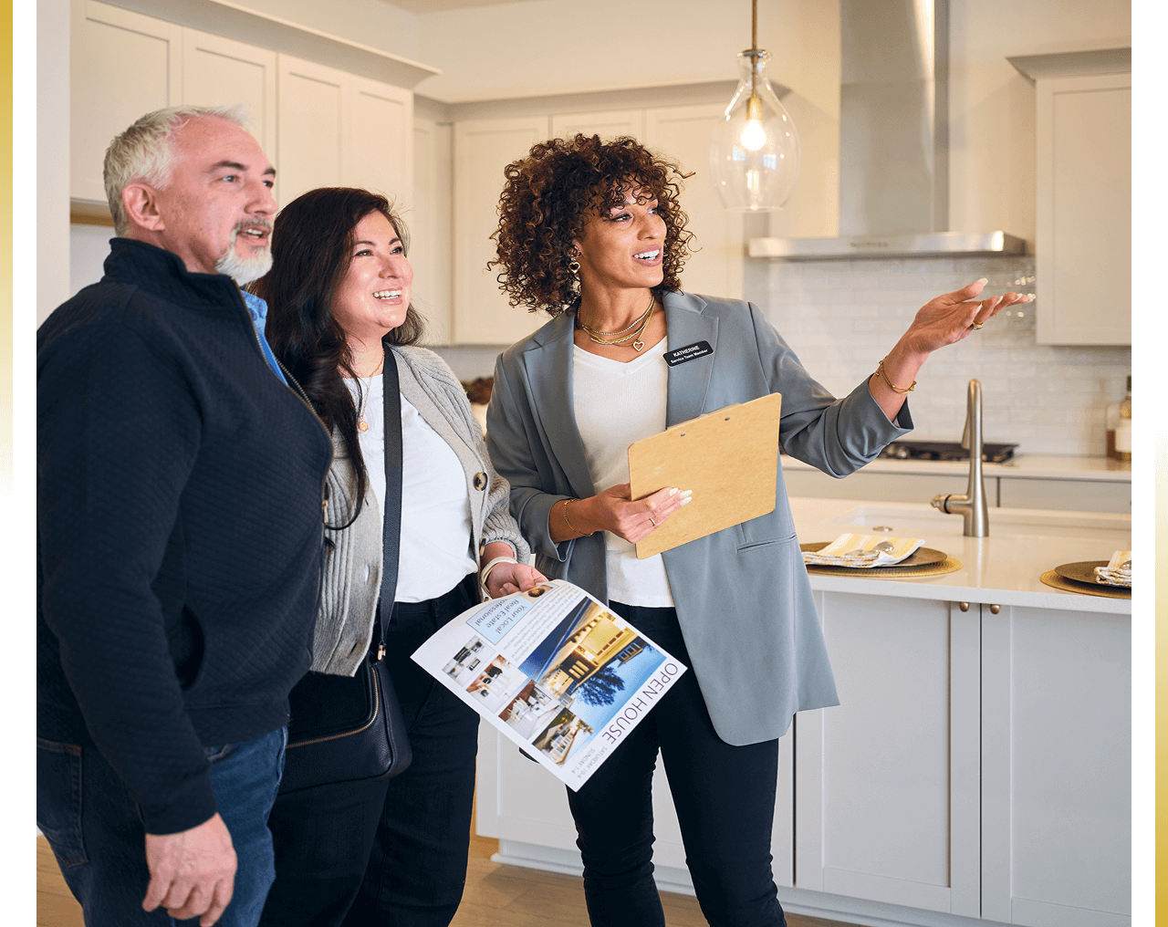 Real estate agent showing kitchen to couple.